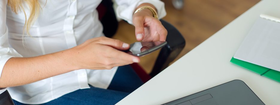 business woman working with mobile phone her office