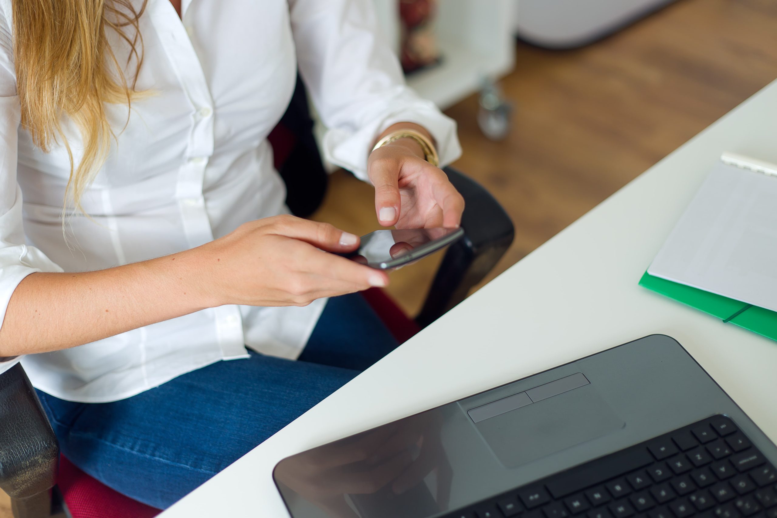 business woman working with mobile phone her office