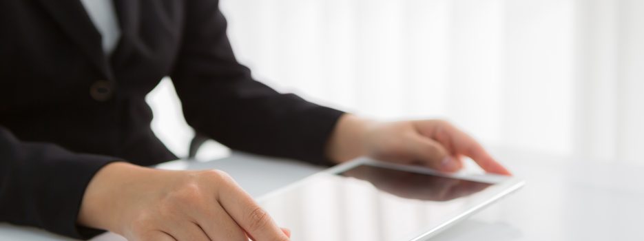 Woman hand touch white tablet with blank empty screen