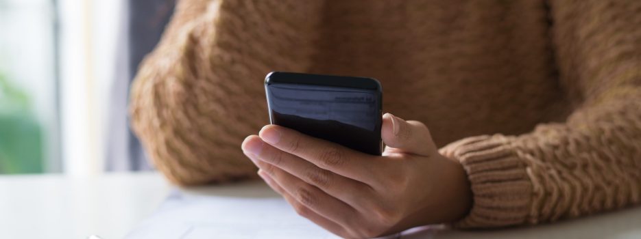 close up busy lady filling document checking sms phone scaled